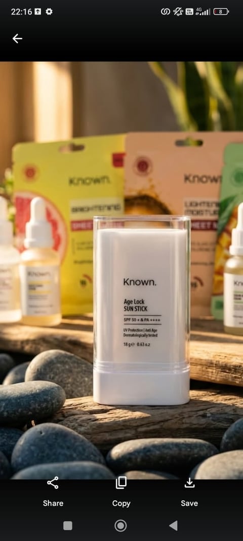 Known Age Lock Sun Stick SPF 50 sunscreen displayed on rocks with product packaging and bottles in background
